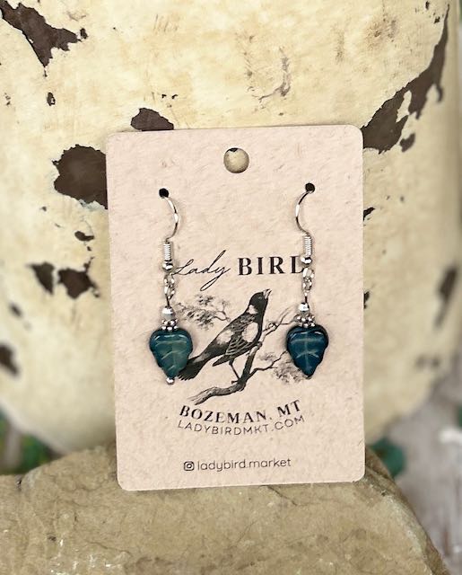 Black etched mini leaf dangle earrings featuring intricate Czech glass craftsmanship with a whimsical owl design.