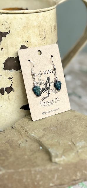 Black etched mini leaf dangle earrings featuring intricate Czech glass craftsmanship with a whimsical owl design.