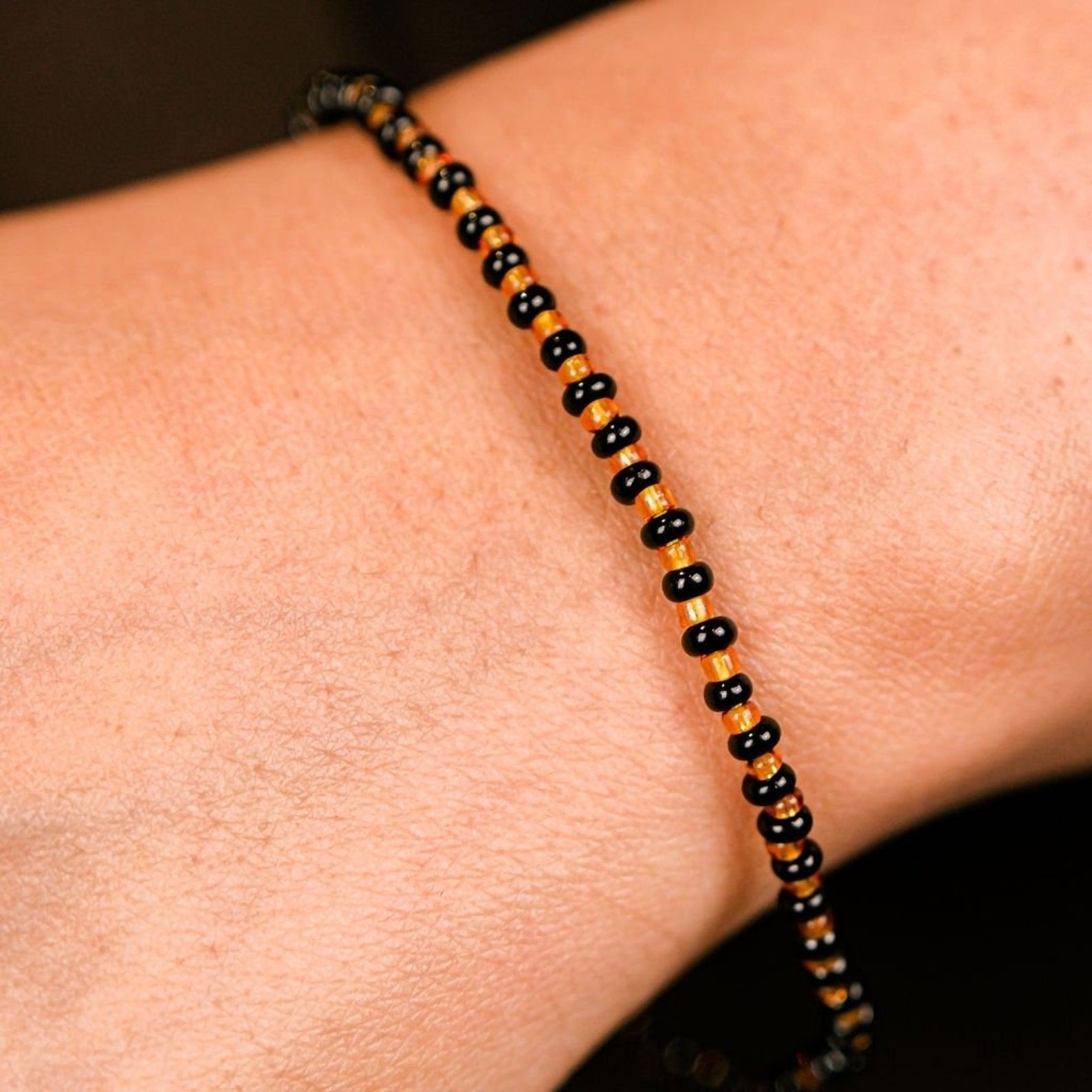 Black Golden Mangalsutra Tiny Black Bead bracelet for kids, featuring exquisite black beads and a golden thread design.