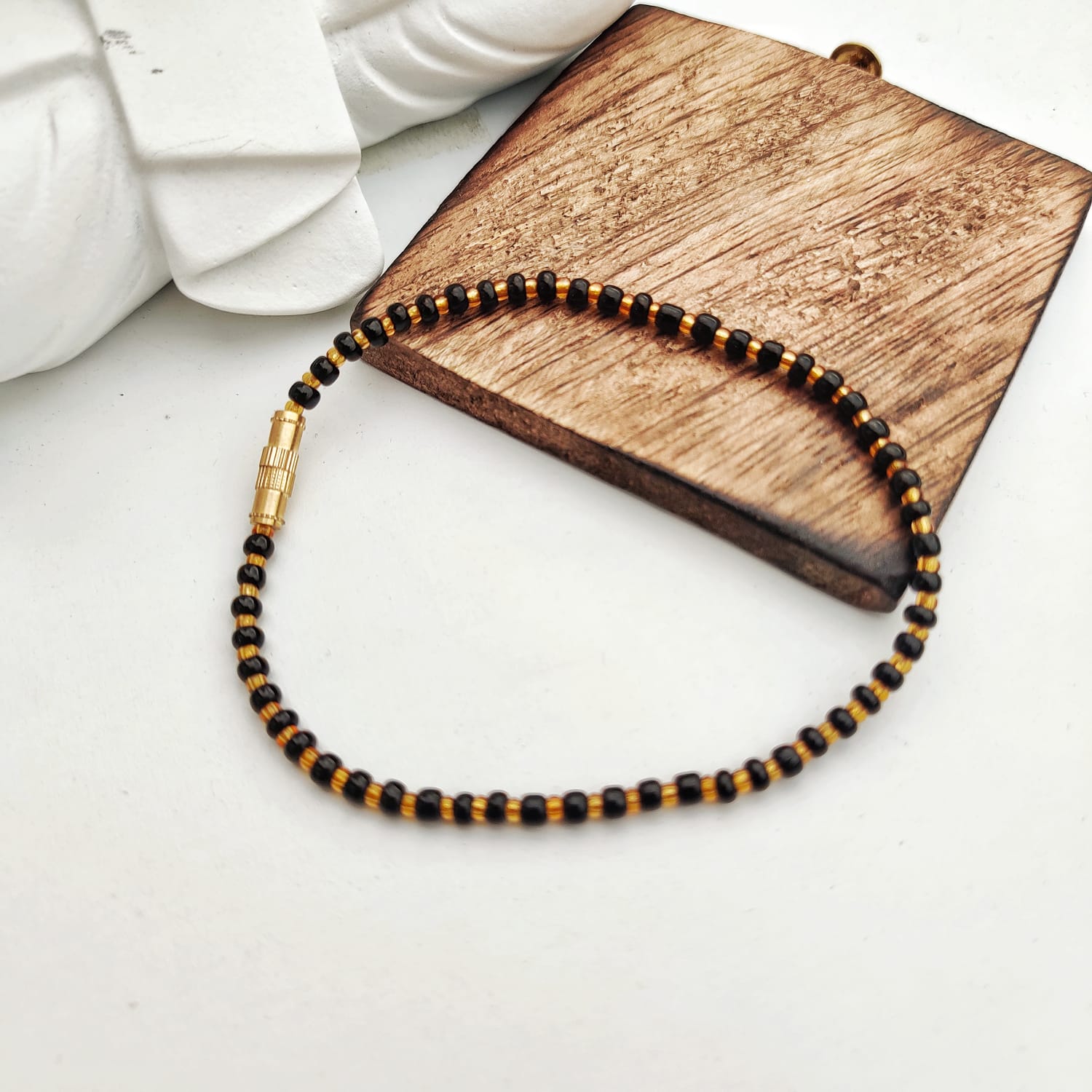 Black Golden Mangalsutra Tiny Black Bead bracelet for kids, featuring exquisite black beads and a golden thread design.