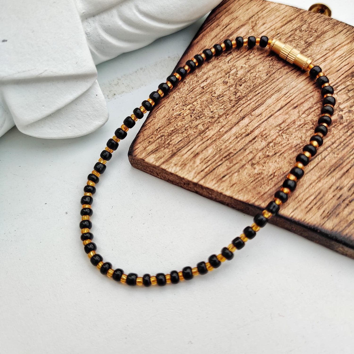 Black Golden Mangalsutra Tiny Black Bead bracelet for kids, featuring exquisite black beads and a golden thread design.