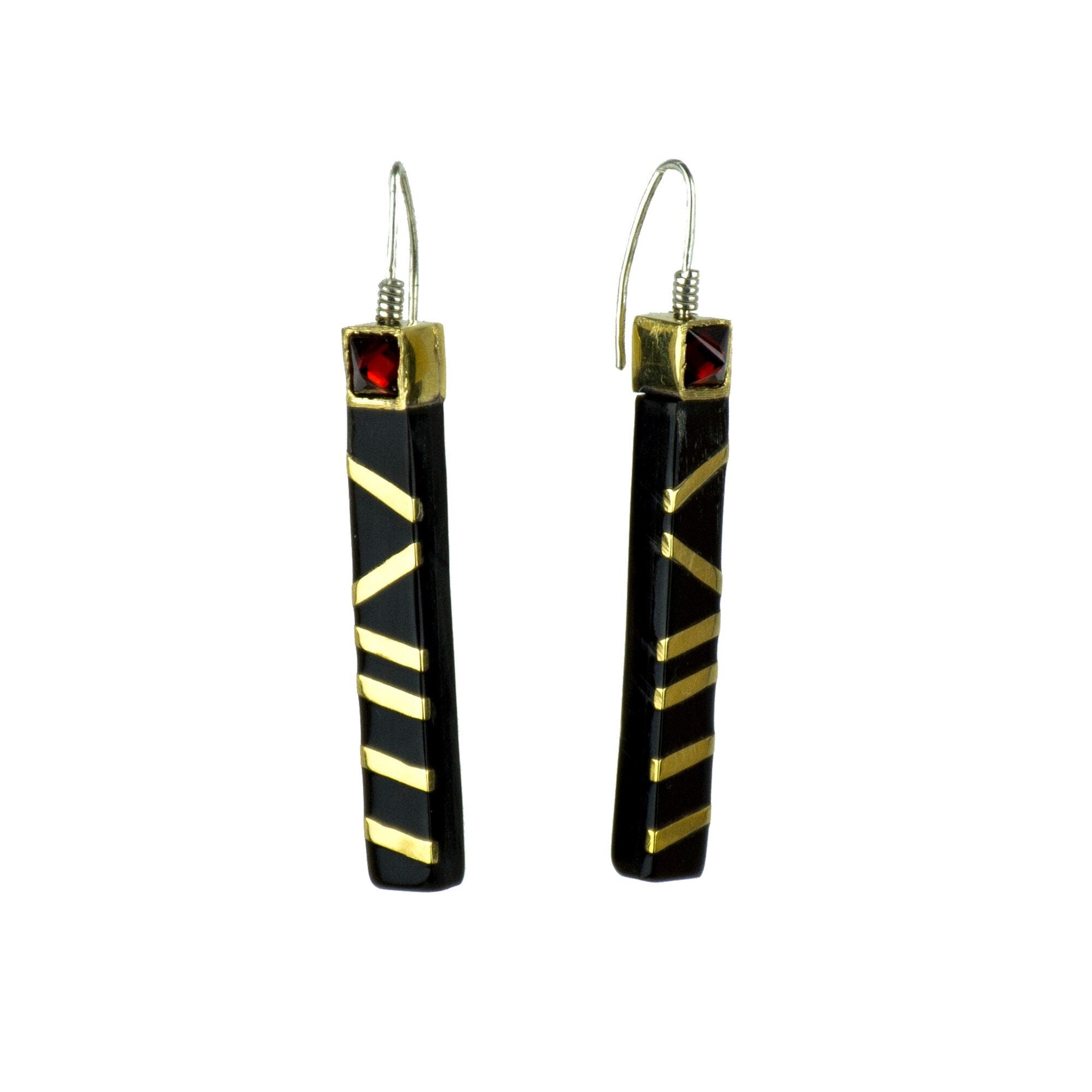 Elegant black jet earrings made from cow horn, featuring gold brass stripes and red zirconia stones, showcasing a unique and stylish design.