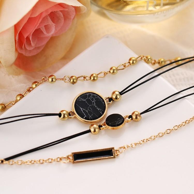 Black Lapis Marble Geometric 4 Piece Bracelet Set featuring 14K gold plating and unique geometric pendants, designed in Italy.