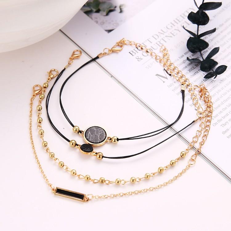 Black Lapis Marble Geometric 4 Piece Bracelet Set featuring 14K gold plating and unique geometric pendants, designed in Italy.