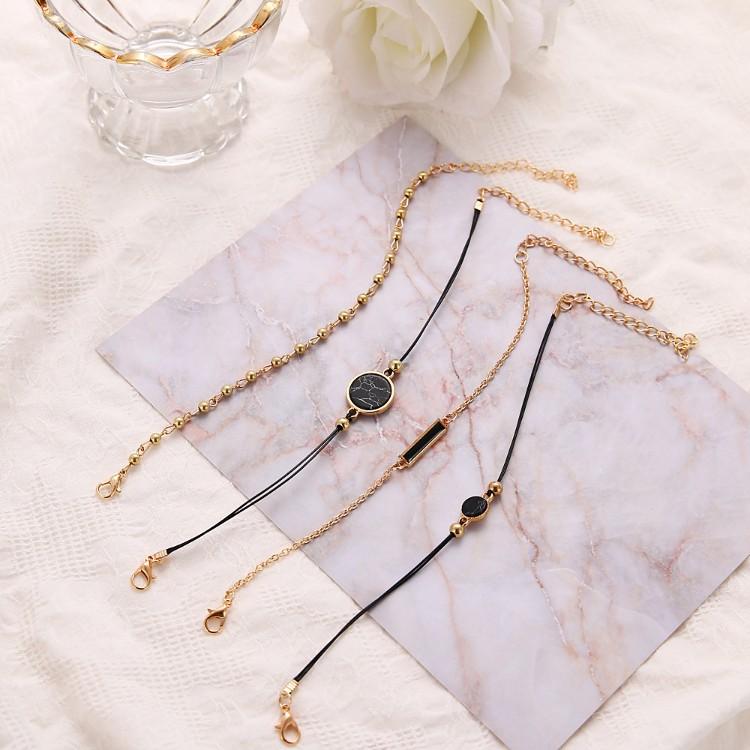 Black Lapis Marble Geometric 4 Piece Bracelet Set featuring 14K gold plating and unique geometric pendants, designed in Italy.