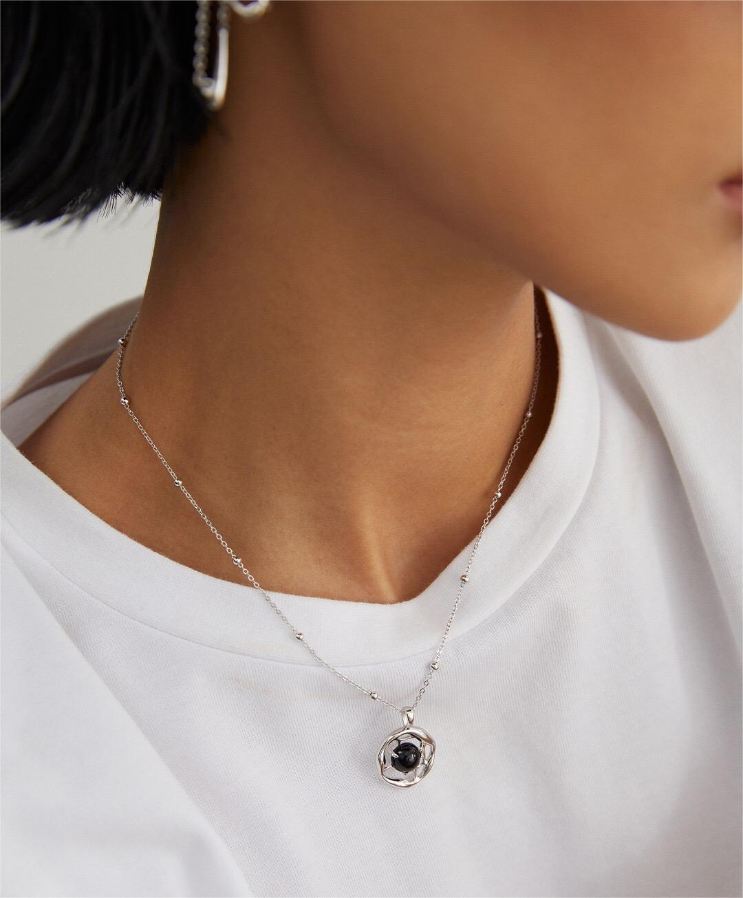 A beautifully handcrafted Black Onyx Pendant Necklace featuring a gold vermeil chain, showcasing a striking black onyx stone.