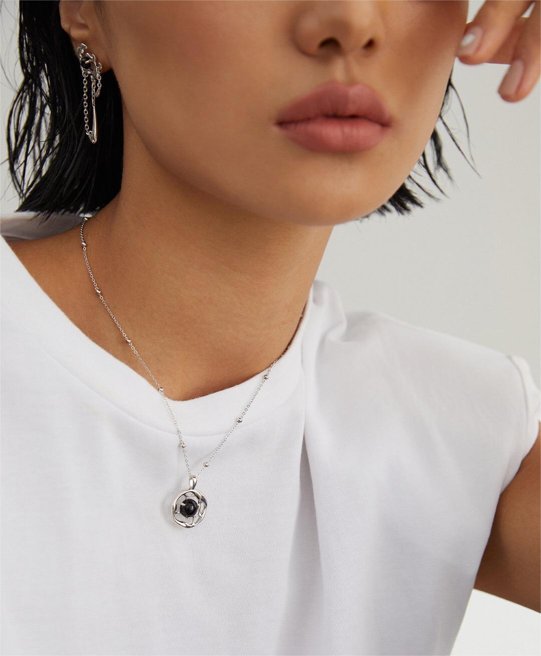 A beautifully handcrafted Black Onyx Pendant Necklace featuring a gold vermeil chain, showcasing a striking black onyx stone.