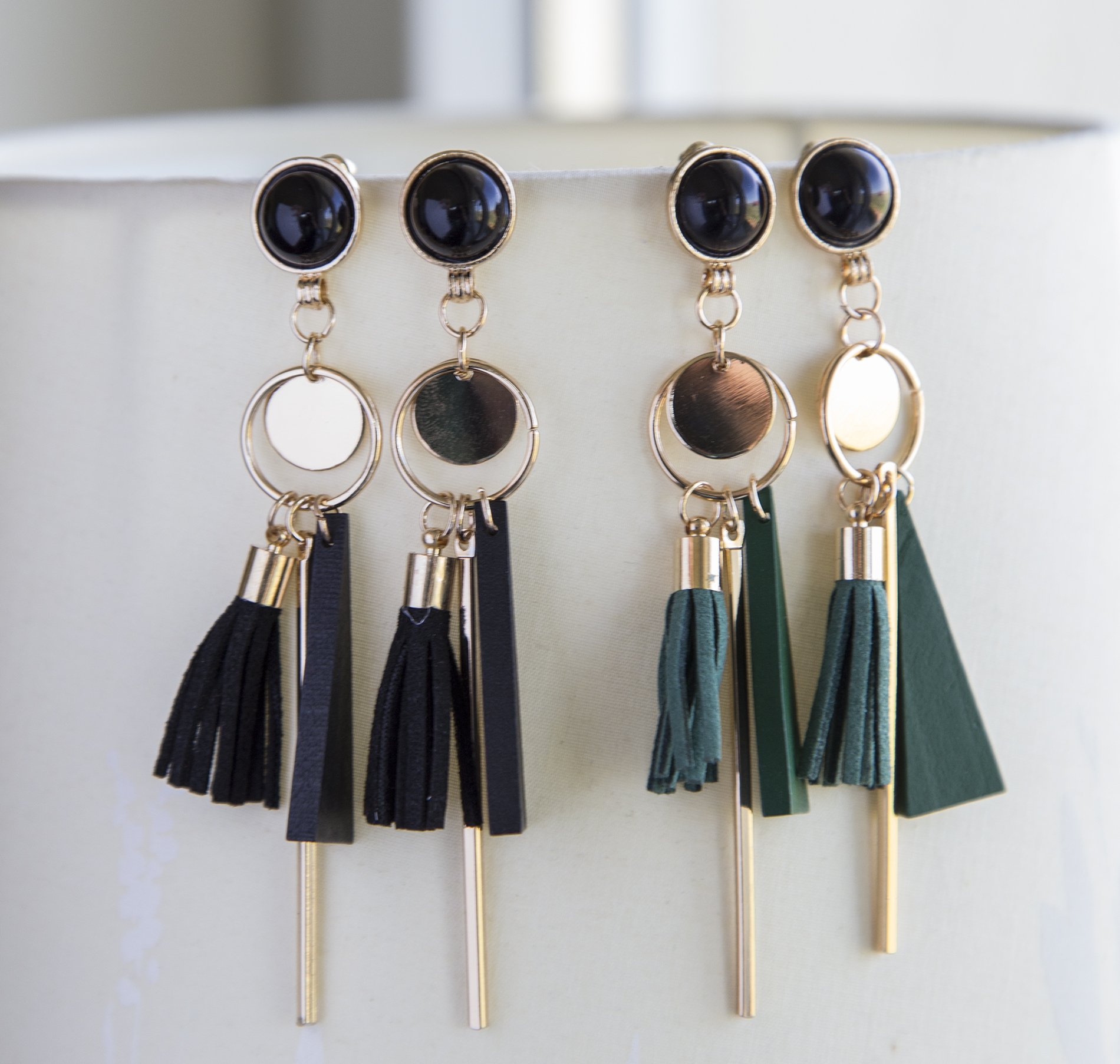 Long black or green tassel boho earrings with gold plated studs, showcasing a stylish design.