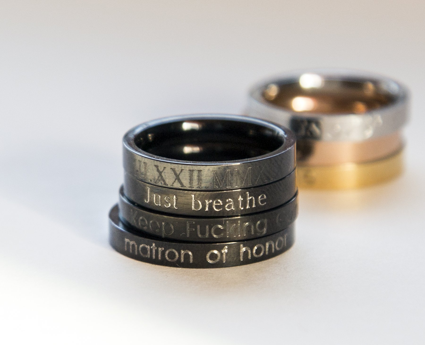 A stylish black stacking ring made of stainless steel with black plating, featuring custom engraving options for personalization.