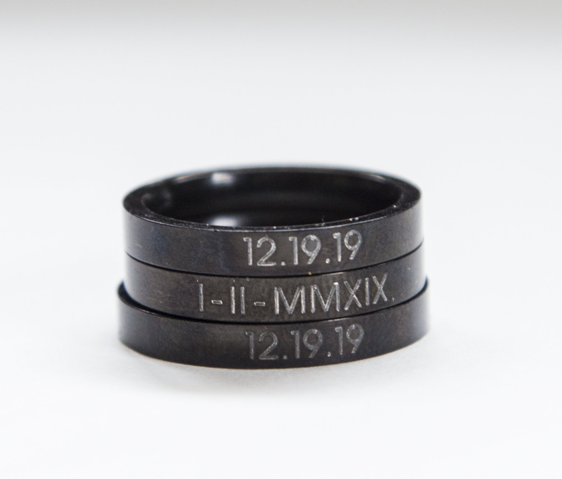 A stylish black stacking ring made of stainless steel with black plating, featuring custom engraving options for personalization.