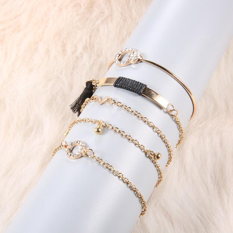 Elegant Black Tassel Pav'e 5 Piece Bracelet Set featuring 14K gold plating and white crystal accents, designed in Italy.