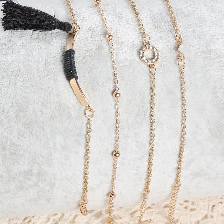 Elegant Black Tassel Pav'e 5 Piece Bracelet Set featuring 14K gold plating and white crystal accents, designed in Italy.