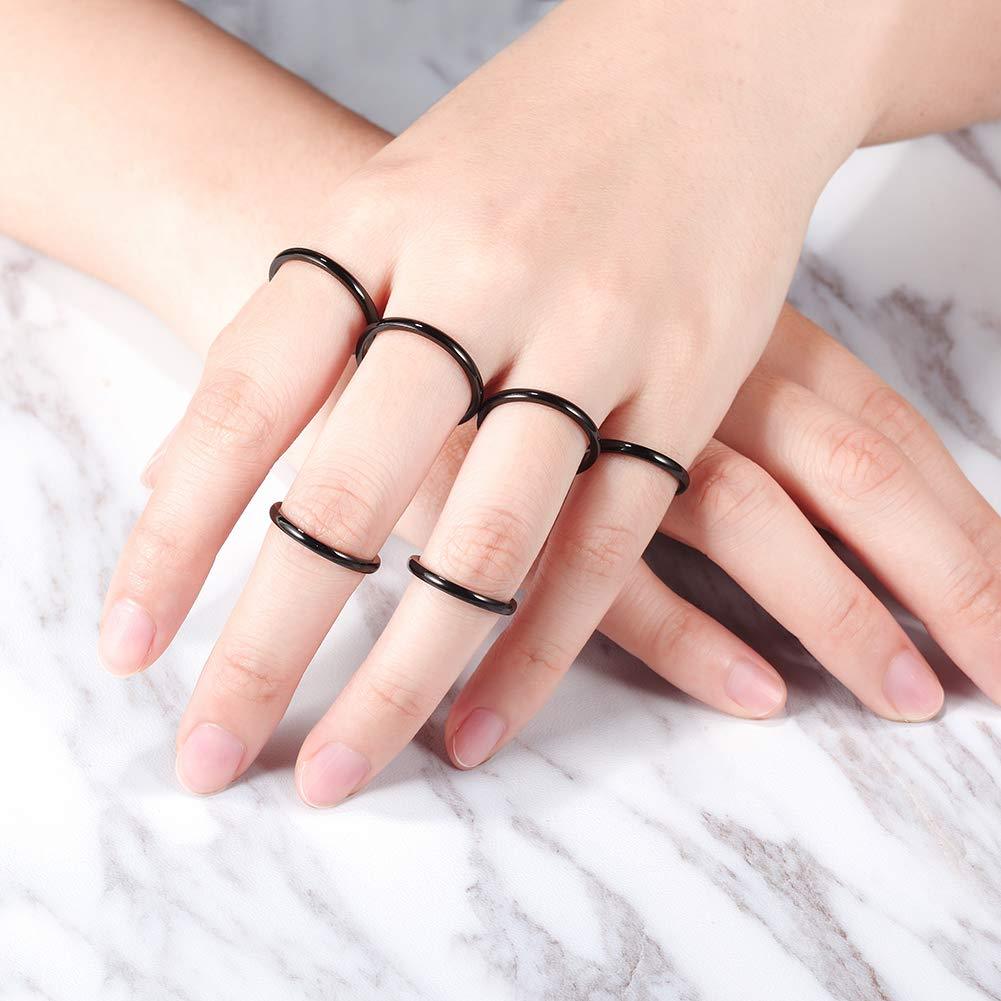 Set of 6 black thin stack rings made from surgical stainless steel with 14K gold PVD plating, showcasing a modern and elegant design.
