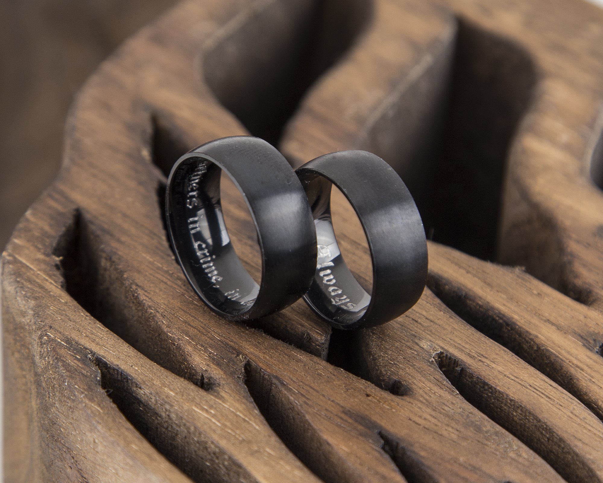 Wide black brushed matte titanium ring for men, showcasing a modern design with a shiny interior and durable exterior.