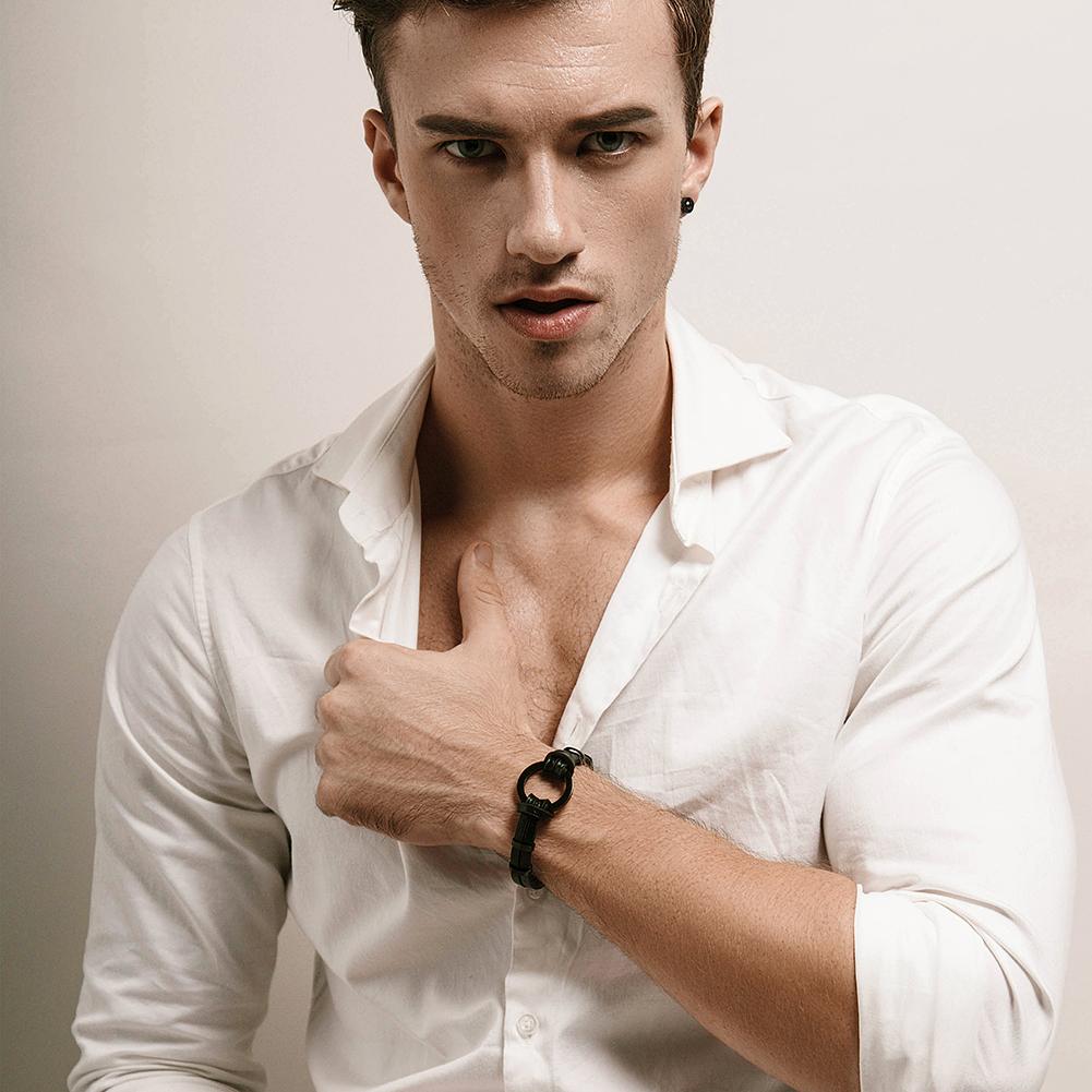 Black and silver circle warp leather bracelet made of stainless steel with gold plating, showcasing a modern design.