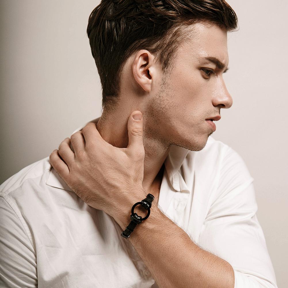 Black and silver circle warp leather bracelet made of stainless steel with gold plating, showcasing a modern design.