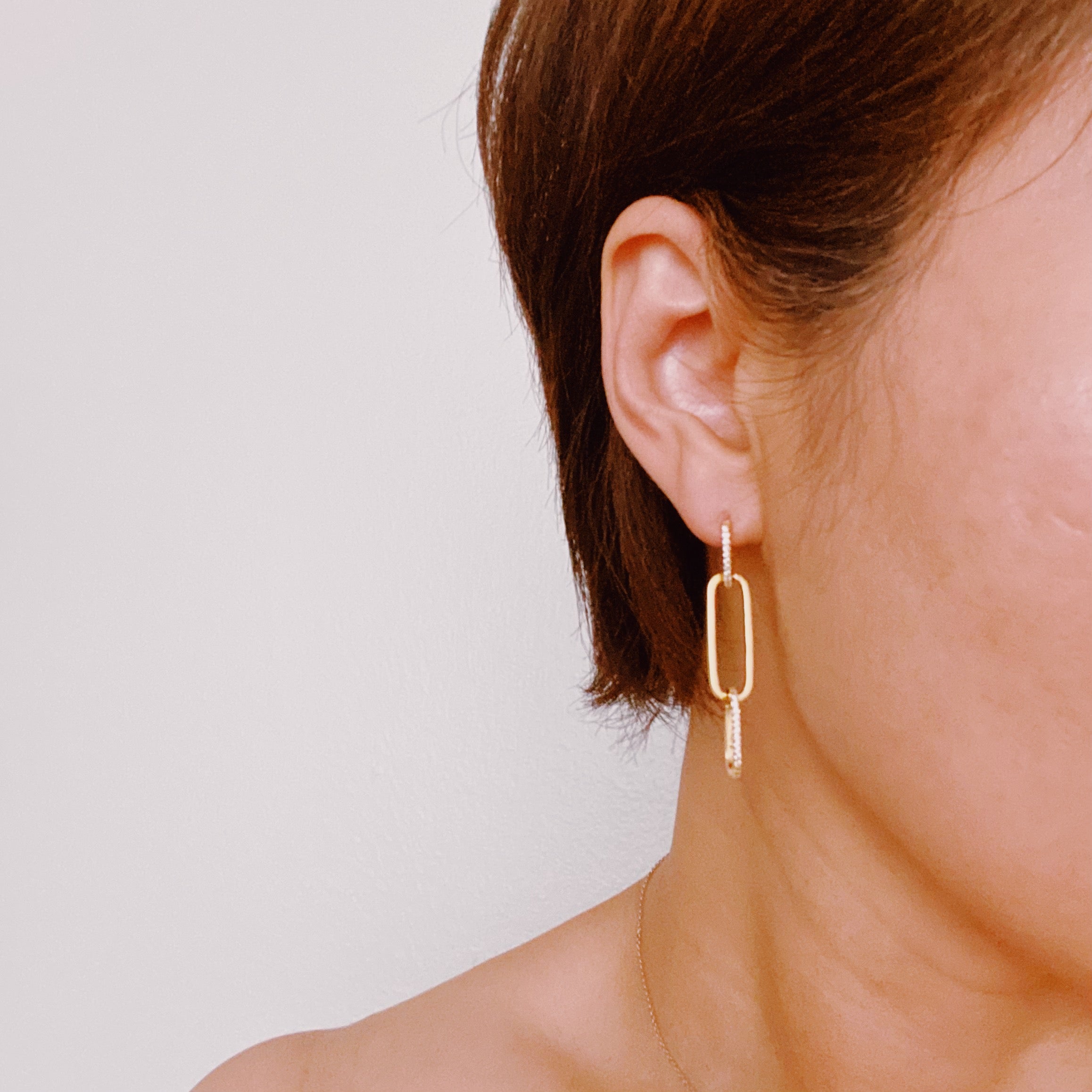 Elegant Blink Link Drop Earrings featuring a modern linked design with sparkling cubic zirconia accents, 18k gold plated brass.