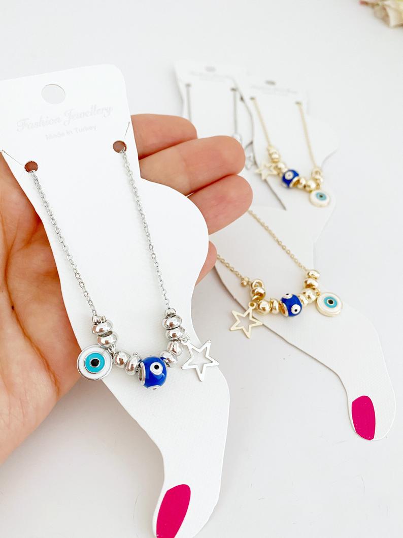 A stylish Blue Evil Eye Anklet featuring a blue evil eye charm and star charm, available in gold and silver finishes.