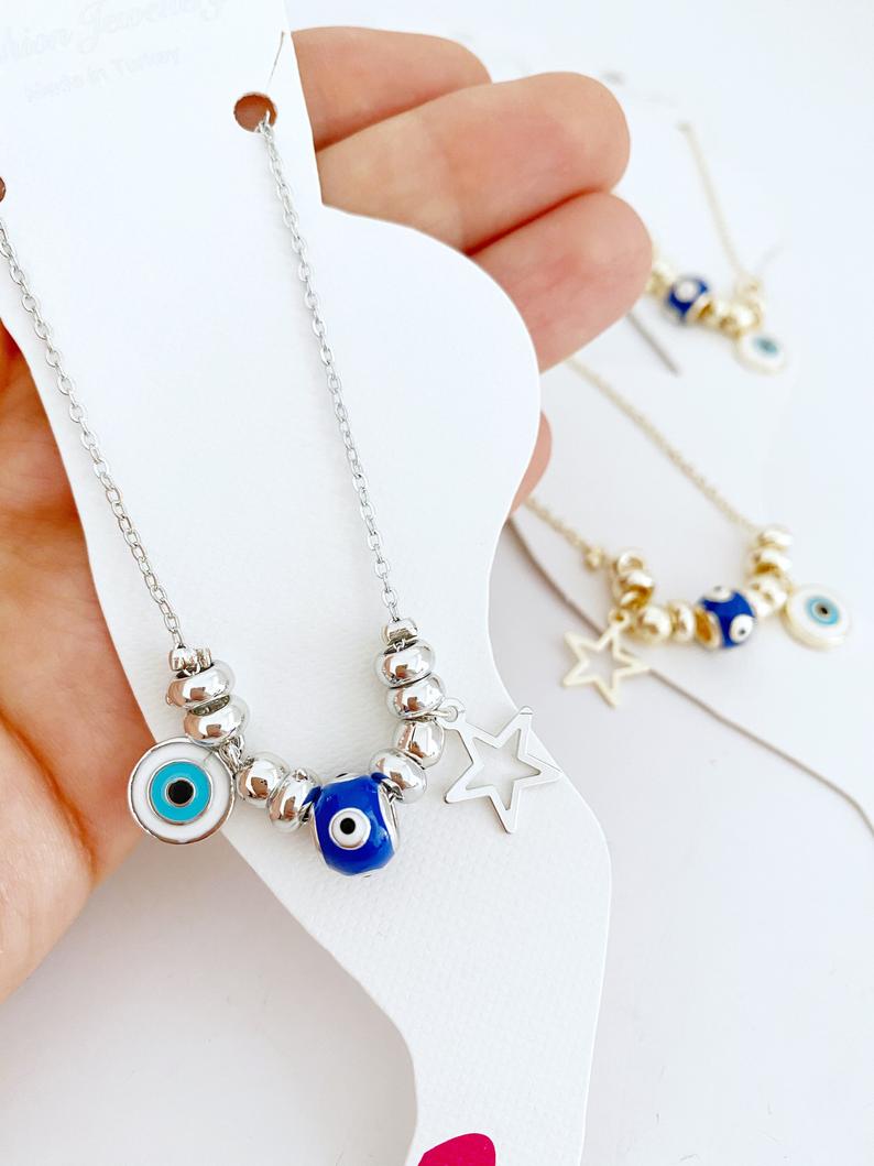 A stylish Blue Evil Eye Anklet featuring a blue evil eye charm and star charm, available in gold and silver finishes.