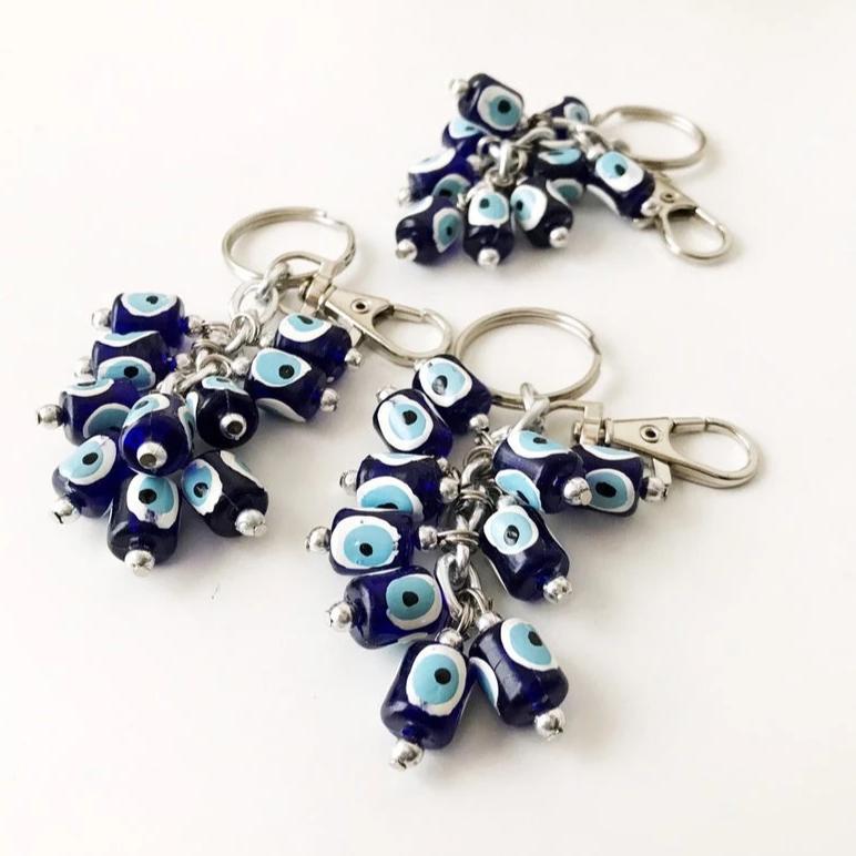 A stylish blue evil eye bag chain featuring resin beads, perfect as a keychain or bag charm.