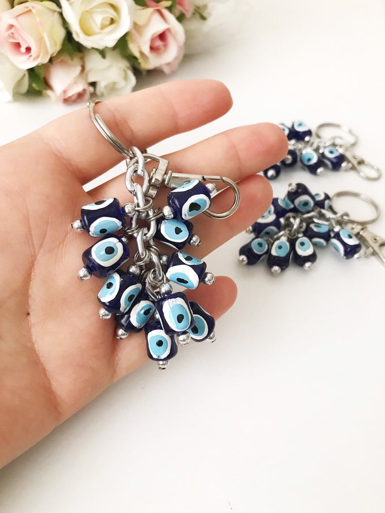 A stylish blue evil eye bag chain featuring resin beads, perfect as a keychain or bag charm.