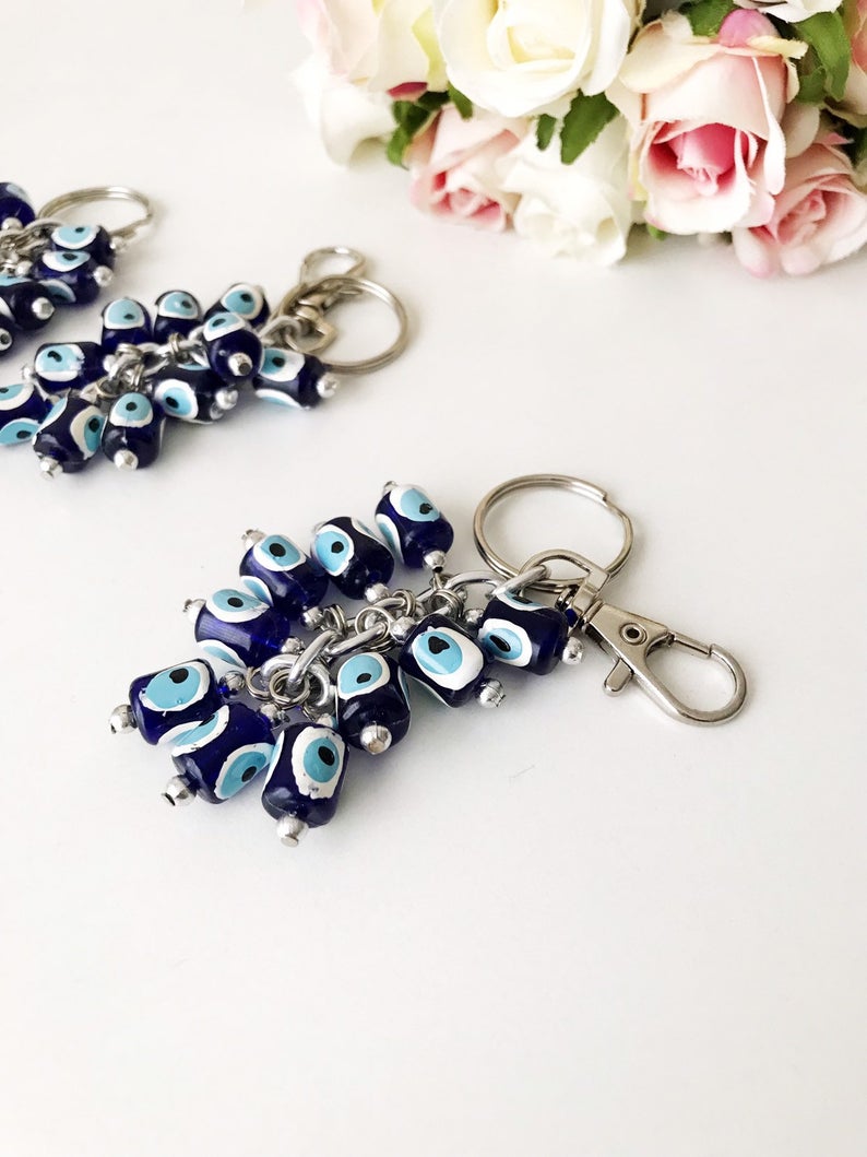 A stylish blue evil eye bag chain featuring resin beads, perfect as a keychain or bag charm.