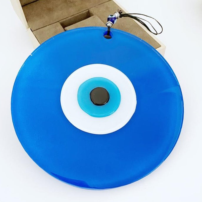 A beautiful 16cm handmade blue evil eye bead with a blue rope for hanging, showcasing intricate glasswork and vibrant color.