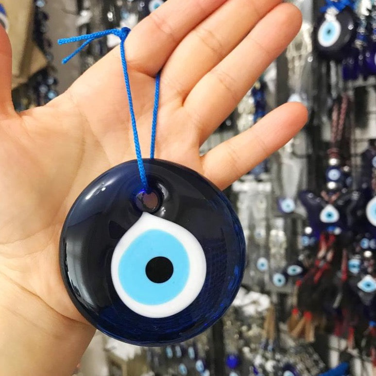 A beautifully handcrafted 7cm blue evil eye bead made from Murano glass, featuring intricate designs and vibrant colors, perfect for home decor and jewelry making.