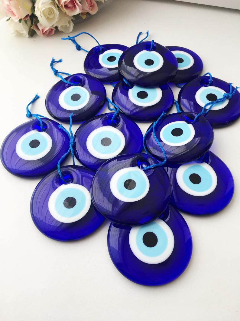 A beautifully handcrafted 7cm blue evil eye bead made from Murano glass, featuring intricate designs and vibrant colors, perfect for home decor and jewelry making.