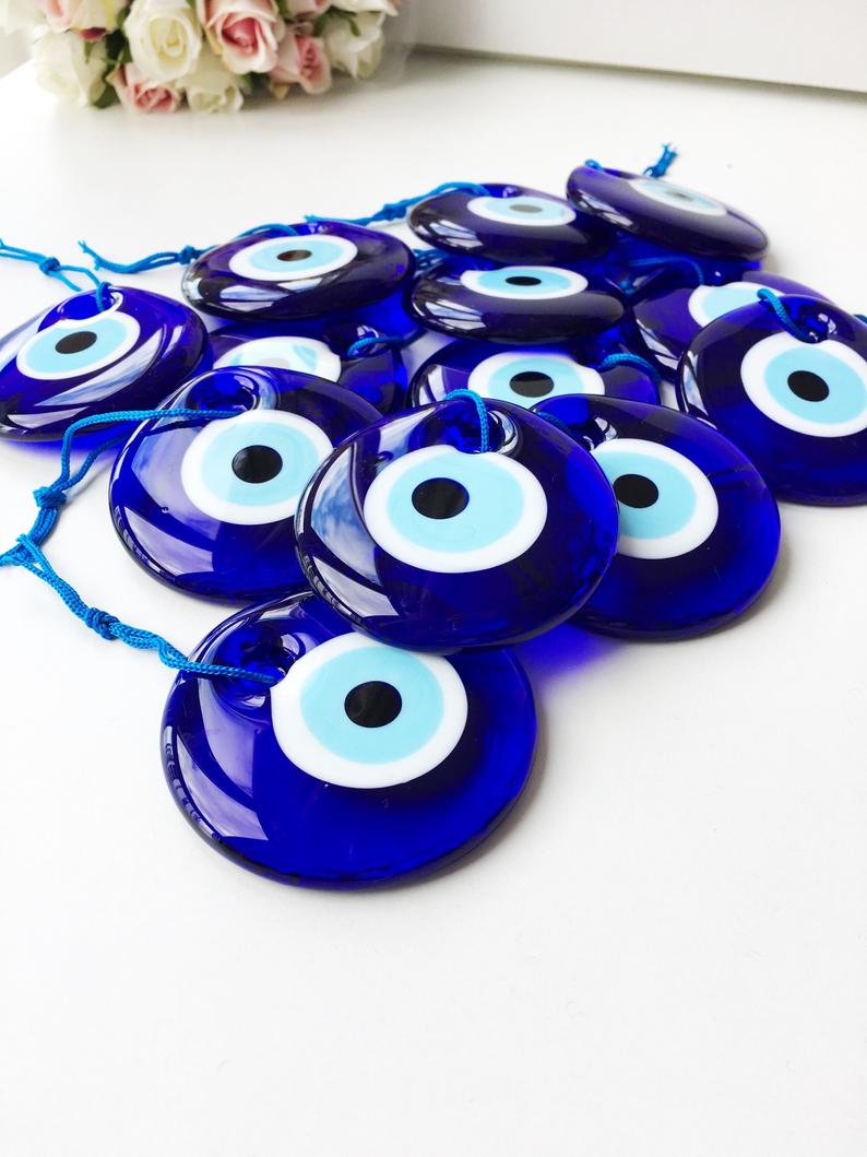 A beautifully handcrafted 7cm blue evil eye bead made from Murano glass, featuring intricate designs and vibrant colors, perfect for home decor and jewelry making.