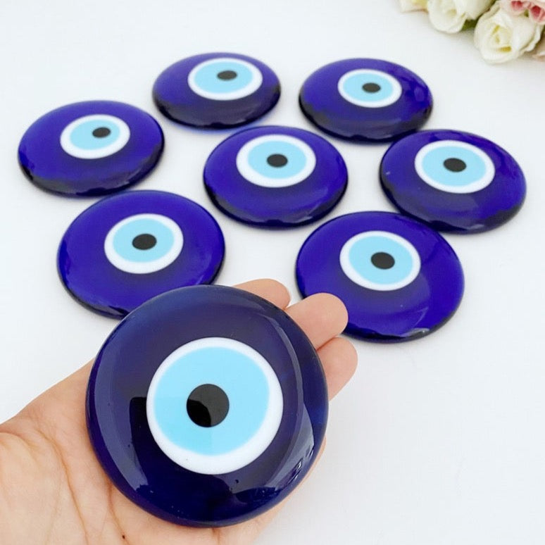 A 7cm handmade blue evil eye bead with no hole, showcasing intricate glasswork and vibrant blue color, symbolizing protection and good luck.