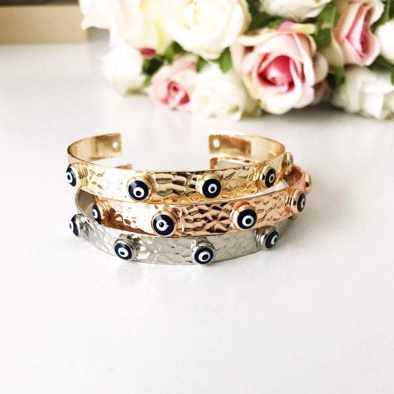 Blue Evil Eye Beaded Bracelet featuring tiny glass beads and a movable oval charm, available in rose gold, gold, and silver.