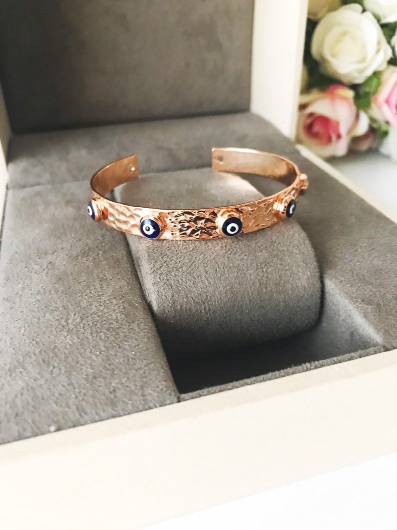 Blue Evil Eye Beaded Bracelet featuring tiny glass beads and a movable oval charm, available in rose gold, gold, and silver.