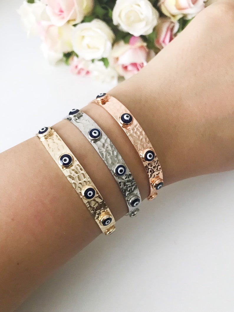 Blue Evil Eye Beaded Bracelet featuring tiny glass beads and a movable oval charm, available in rose gold, gold, and silver.