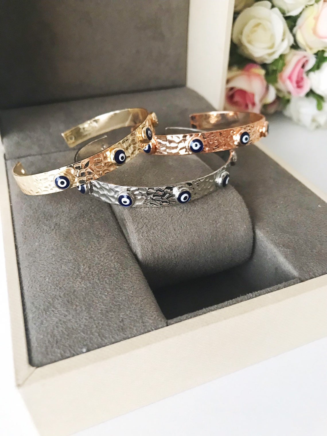 Blue Evil Eye Beaded Bracelet featuring tiny glass beads and a movable oval charm, available in rose gold, gold, and silver.