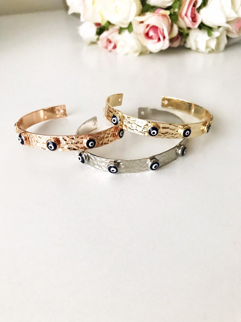 Blue Evil Eye Beaded Bracelet featuring tiny glass beads and a movable oval charm, available in rose gold, gold, and silver.