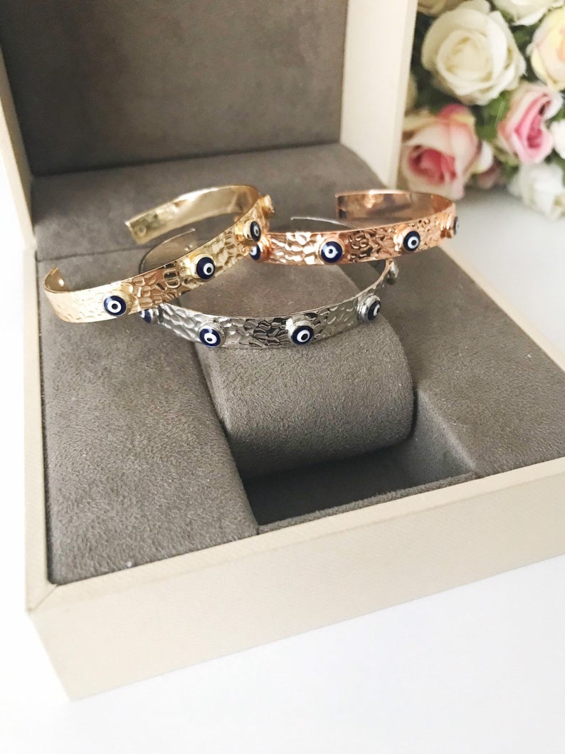 Blue Evil Eye Beaded Bracelet featuring tiny glass beads and a movable oval charm, available in rose gold, gold, and silver.