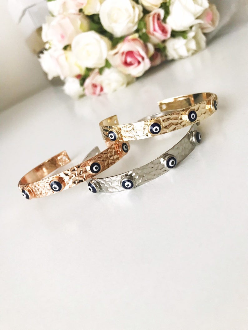 Blue Evil Eye Beaded Bracelet featuring tiny glass beads and a movable oval charm, available in rose gold, gold, and silver.