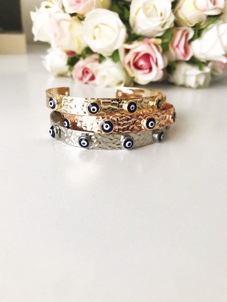 Blue Evil Eye Beaded Bracelet featuring tiny glass beads and a movable oval charm, available in rose gold, gold, and silver.
