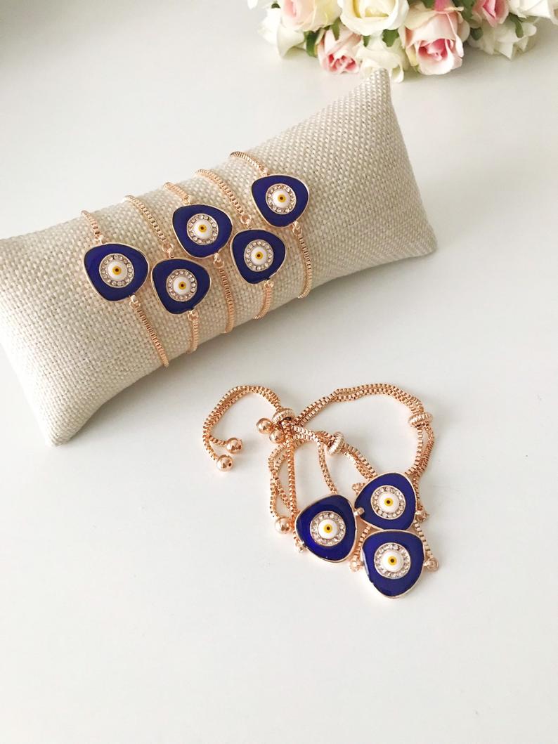 A beautiful blue evil eye bracelet featuring a 15mm charm, adjustable rose gold design, and made from tarnish-resistant stainless steel.