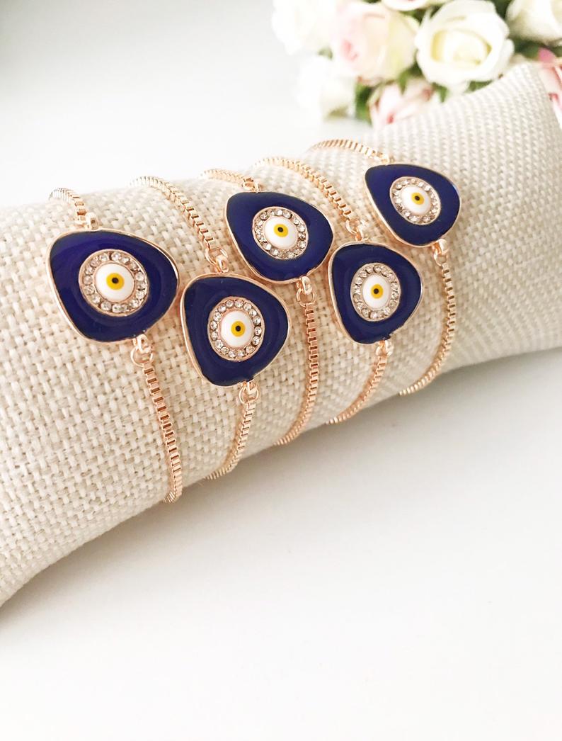 A beautiful blue evil eye bracelet featuring a 15mm charm, adjustable rose gold design, and made from tarnish-resistant stainless steel.