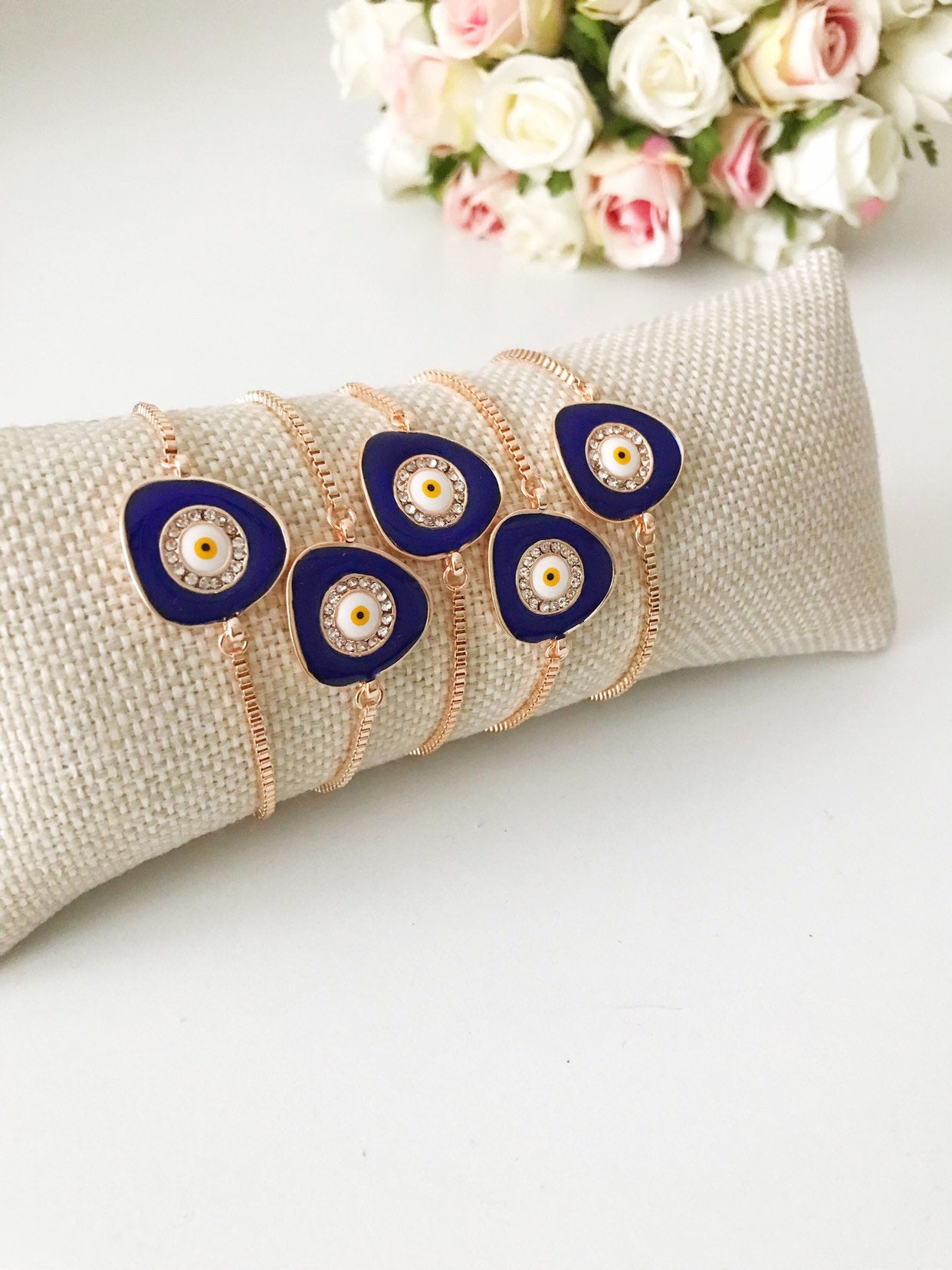 A beautiful blue evil eye bracelet featuring a 15mm charm, adjustable rose gold design, and made from tarnish-resistant stainless steel.