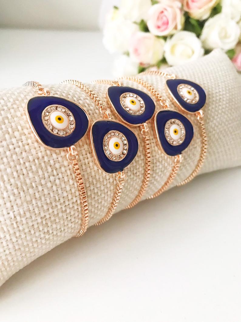 A beautiful blue evil eye bracelet featuring a 15mm charm, adjustable rose gold design, and made from tarnish-resistant stainless steel.
