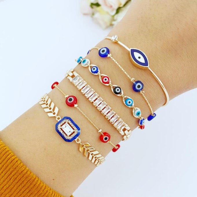 A beautiful Blue Evil Eye Bracelet featuring a gold chain and crystal CZ accents, showcasing its handmade craftsmanship and adjustable design.