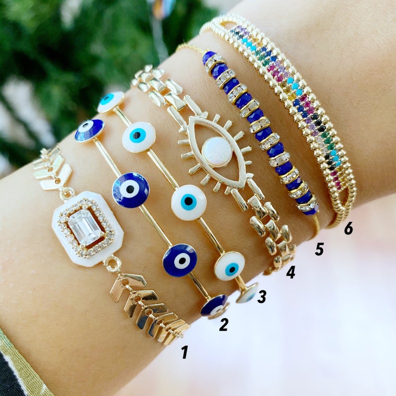 A beautiful Blue Evil Eye Bracelet featuring a gold chain and adjustable design, handmade with 316L stainless steel for durability.