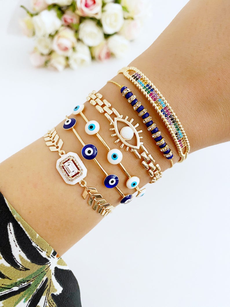 A beautiful Blue Evil Eye Bracelet featuring a gold chain and adjustable design, handmade with 316L stainless steel for durability.