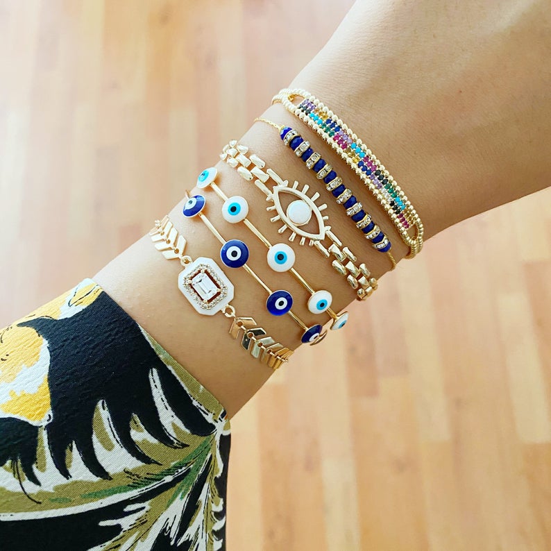 A beautiful Blue Evil Eye Bracelet featuring a gold chain and adjustable design, handmade with 316L stainless steel for durability.