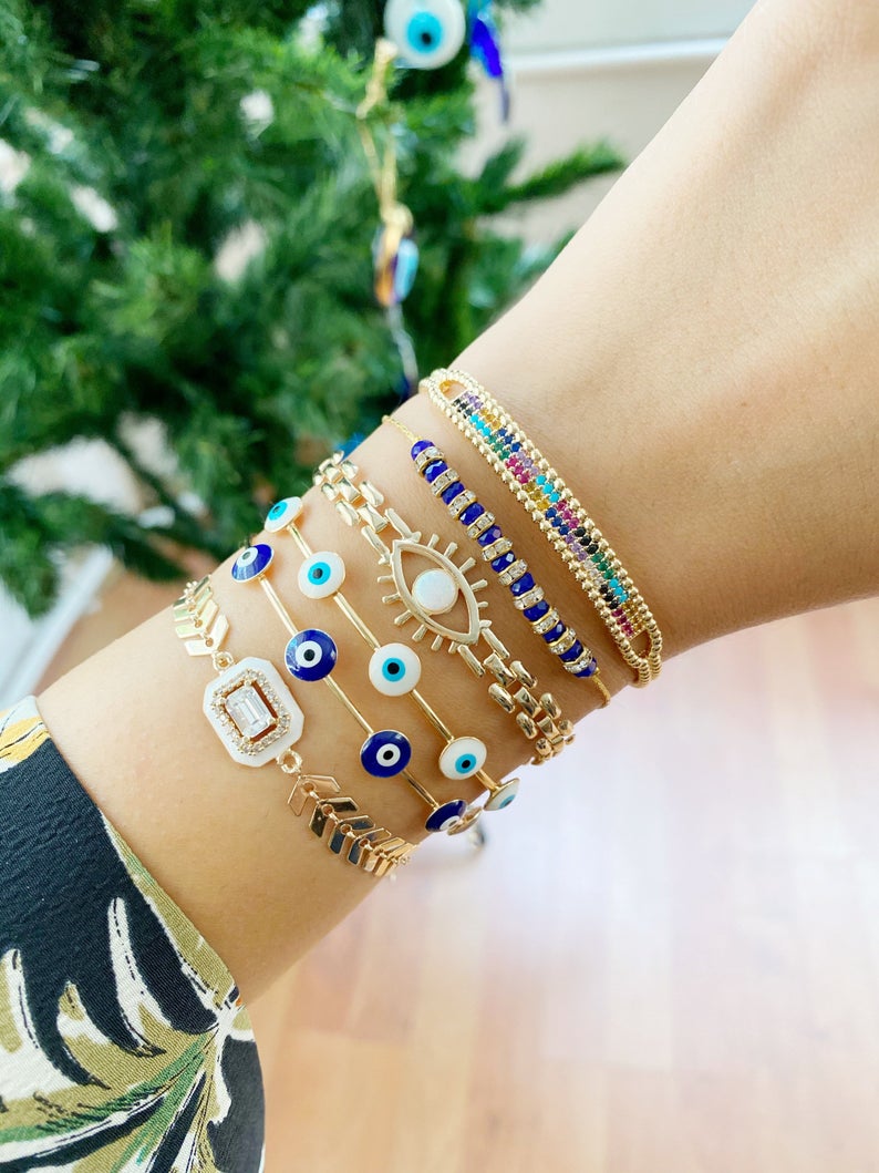 A beautiful Blue Evil Eye Bracelet featuring a gold chain and adjustable design, handmade with 316L stainless steel for durability.