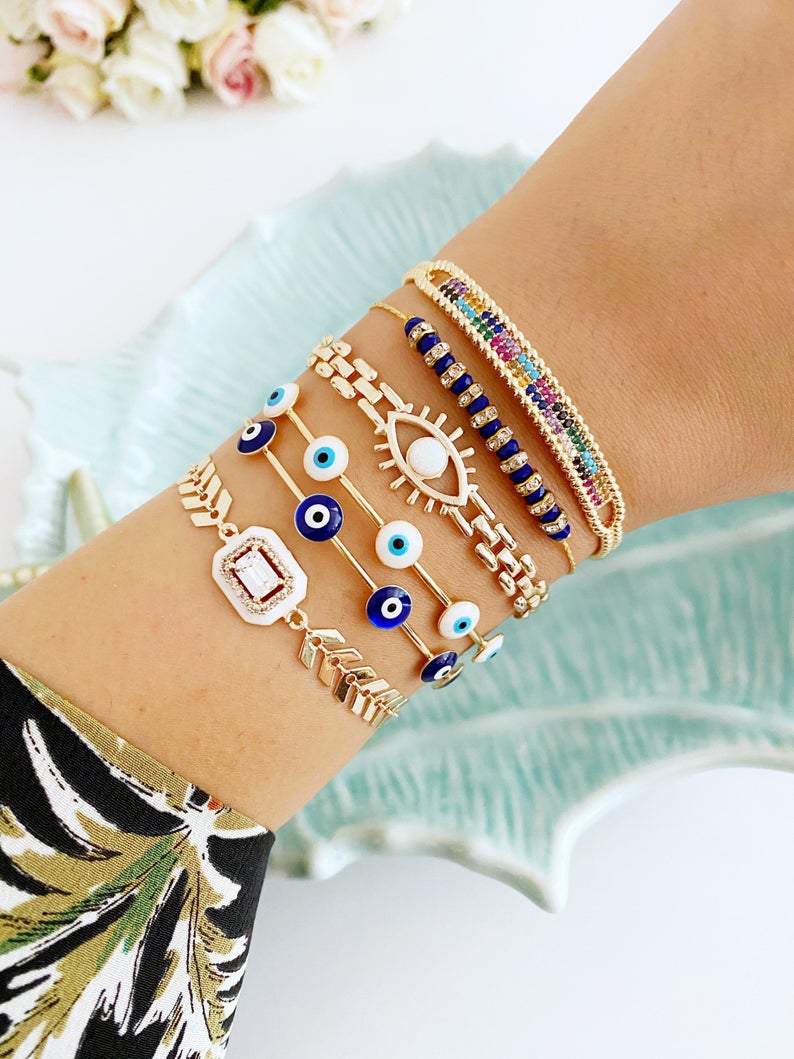 A beautiful Blue Evil Eye Bracelet featuring a gold chain and adjustable design, handmade with 316L stainless steel for durability.