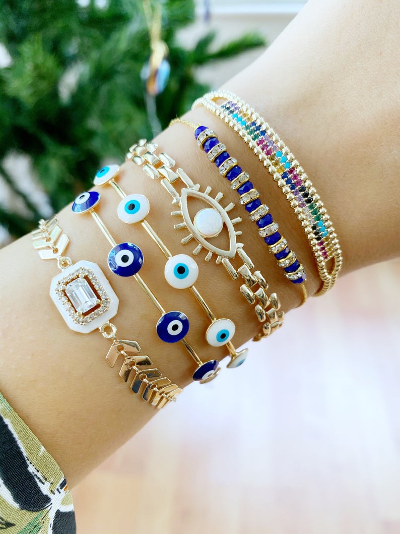 A beautiful Blue Evil Eye Bracelet featuring a gold chain and adjustable design, handmade with 316L stainless steel for durability.